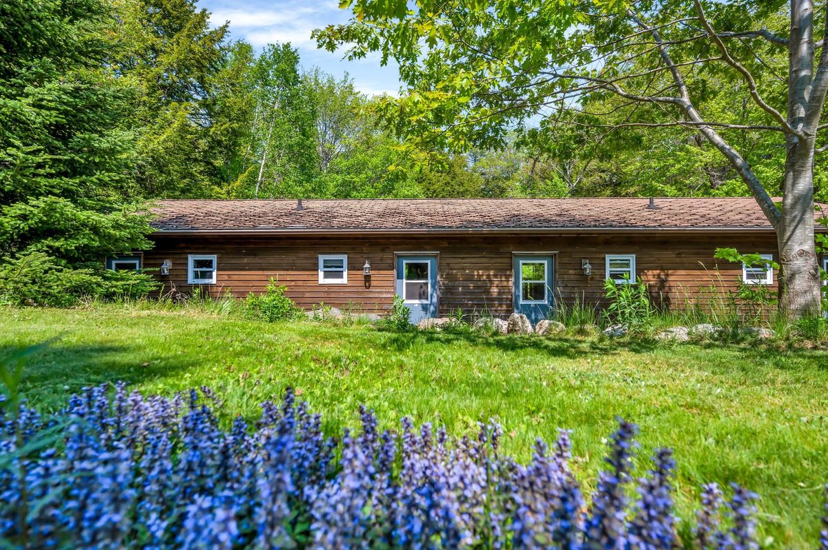 Lodge rooms surrounded by trees and flowers